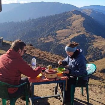 Ashmita Trek and Tours guest pic during Breakfast time at Phalut with background ridge pic