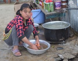 Local resident of the village washing the organic carrot